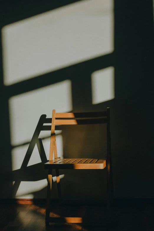 the sun casting a shadow over a brown chair