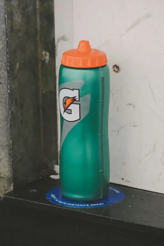 there is an orange lid on a bottle