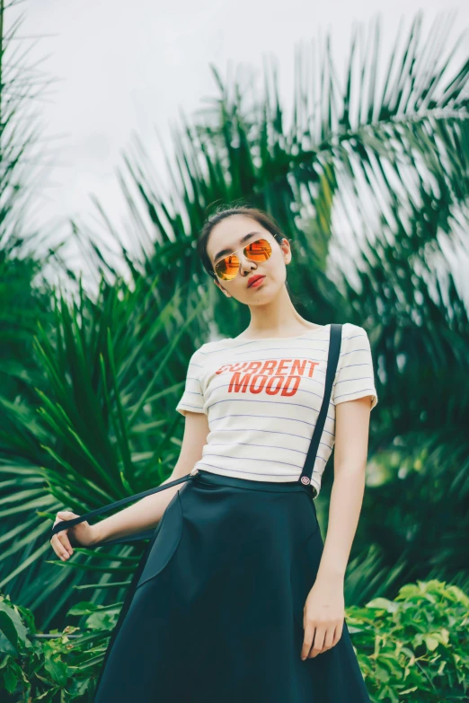 woman posing with sunglasses and a t - shirt