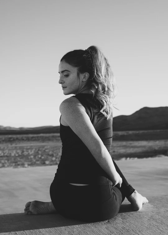 a young woman poses for a black and white po