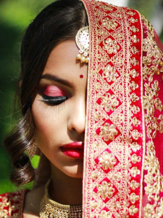 a woman in red indian wedding clothes