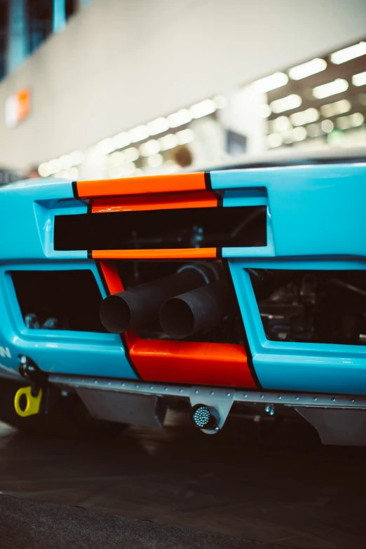 the front bumper of a blue and orange sports car