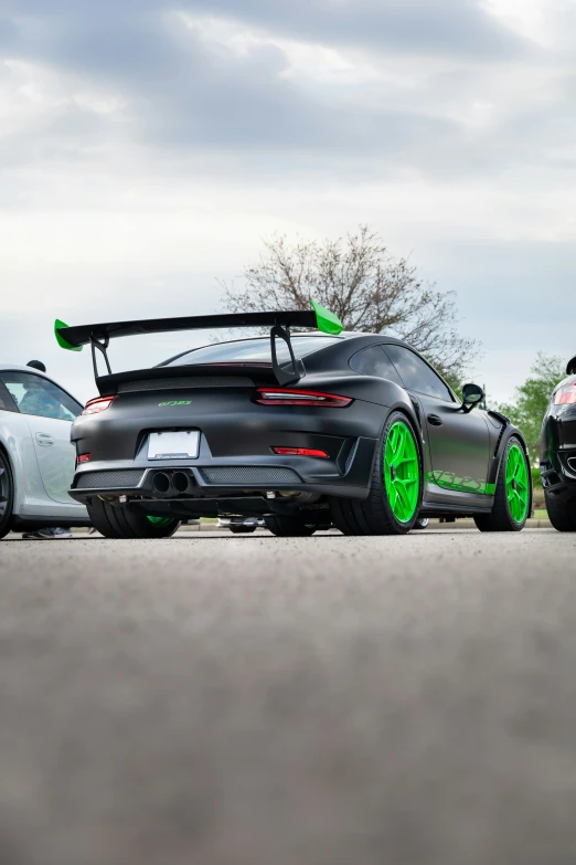 two white sports cars parked near one another