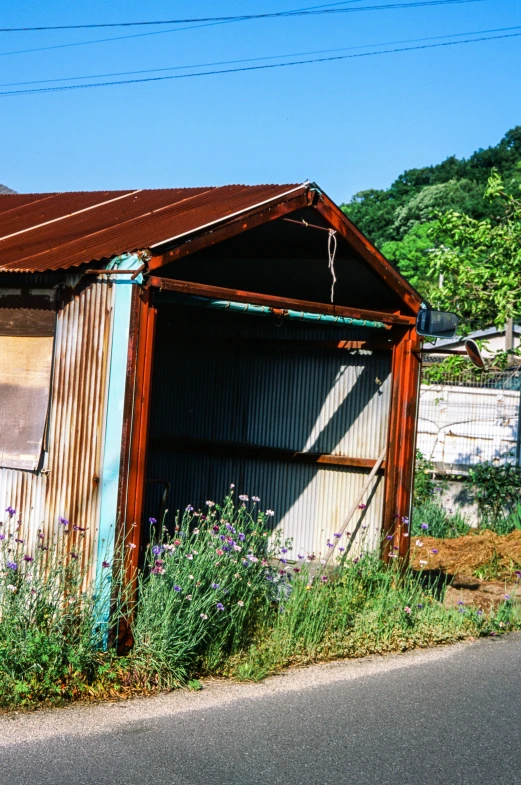 an old building with lots of rust sits in the middle of nowhere