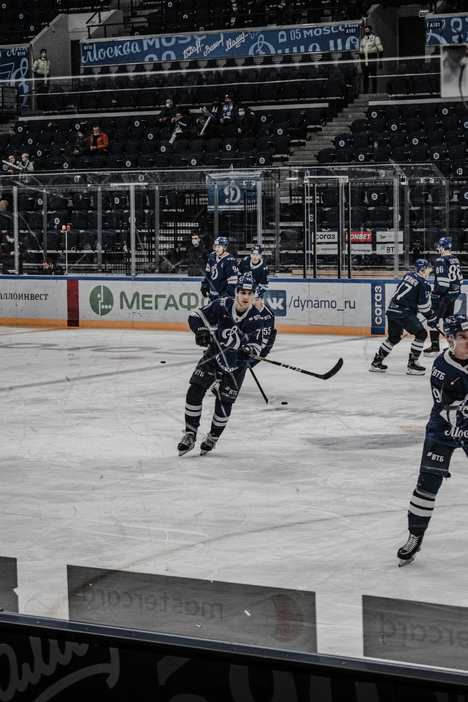 two players in blue hockey uniforms on an ice rink