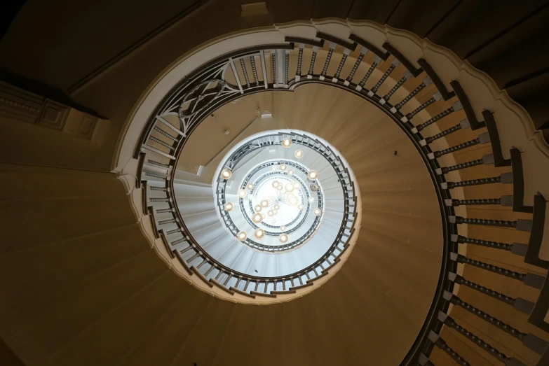 a spiral stair case with circular railing next to it