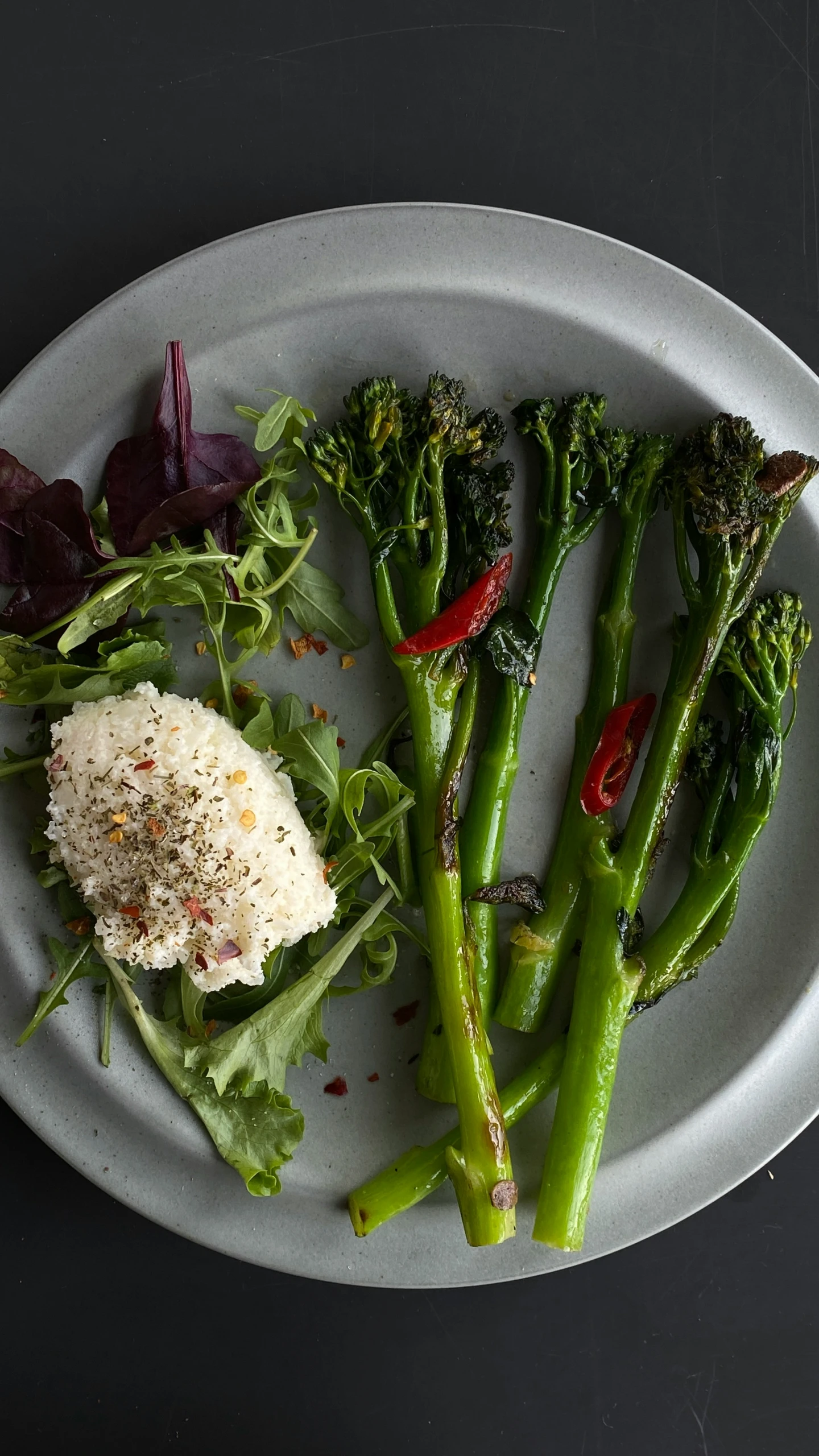 some food on a white plate with broccoli