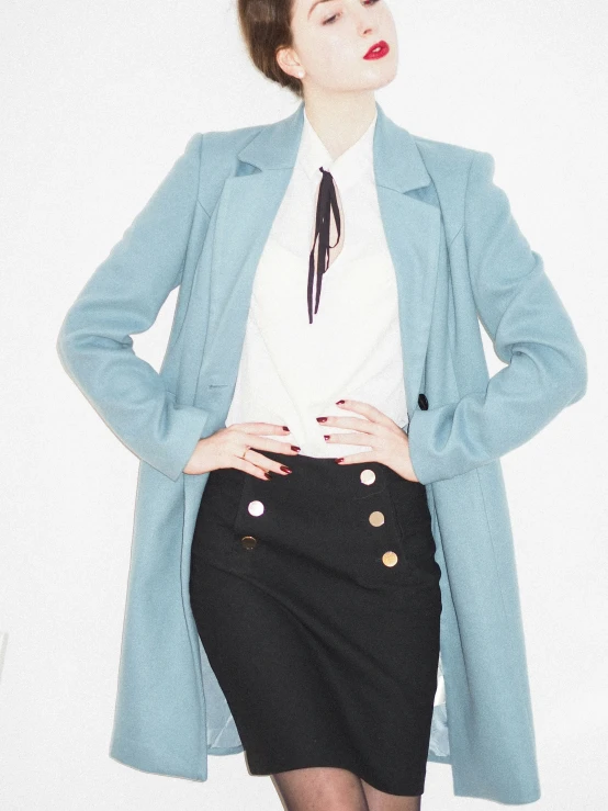 a young woman wearing black skirt and a blue jacket