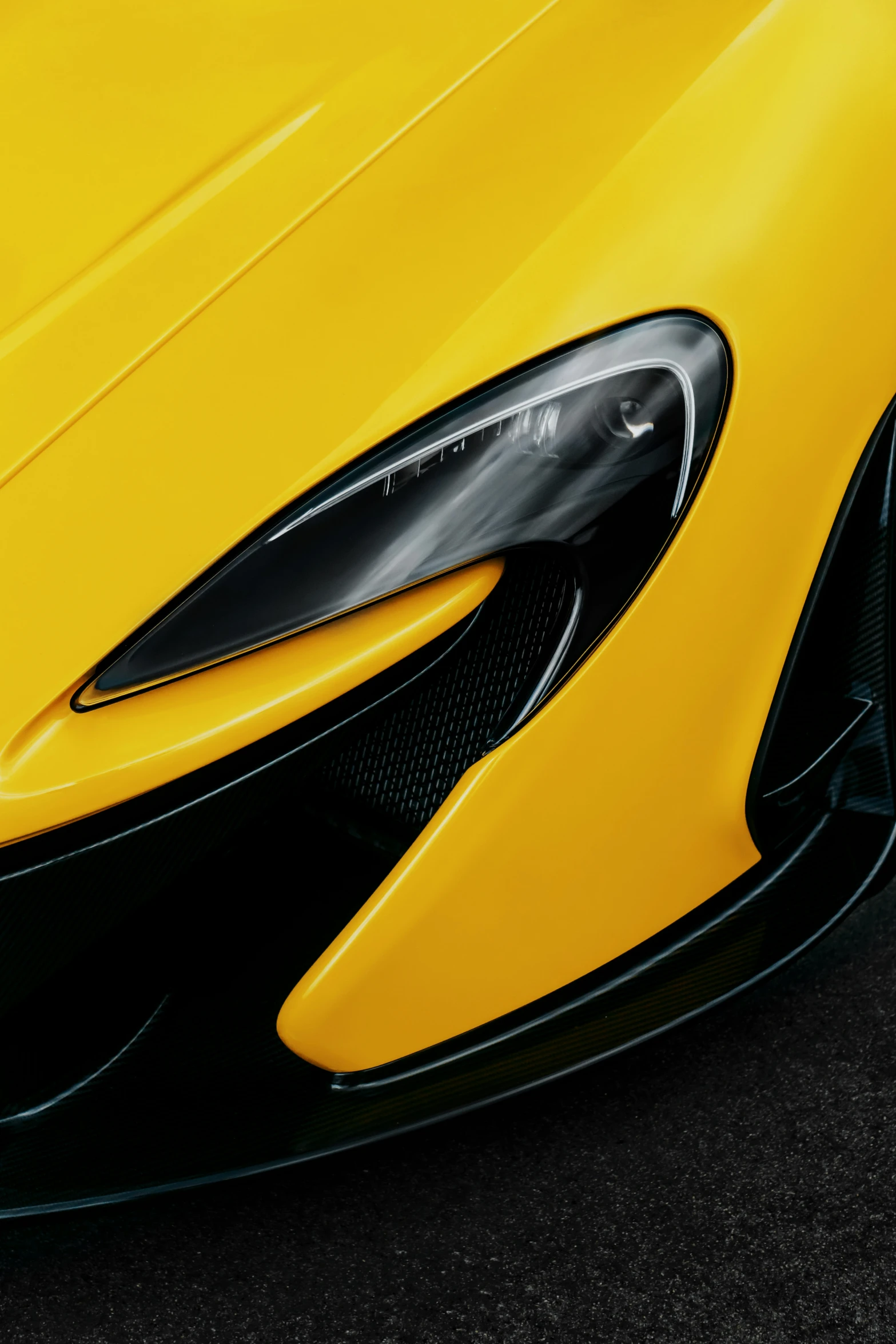 a close up of the front of an orange sports car