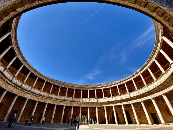 an arch between two buildings on one side with the sky in the background