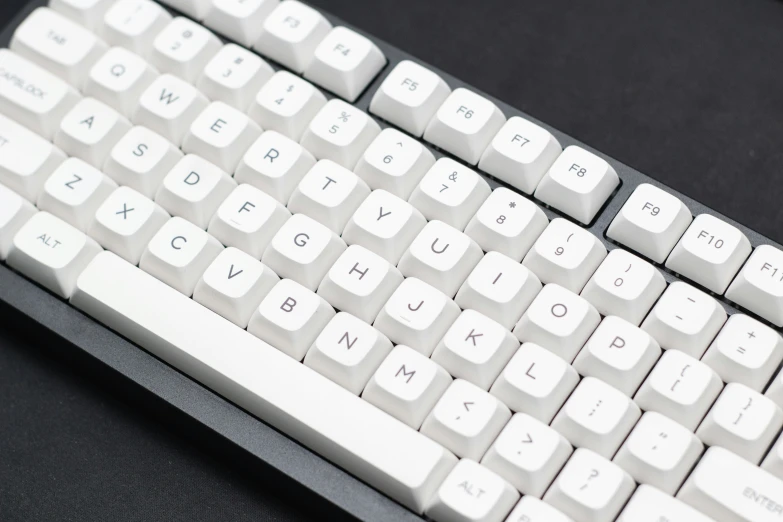 a black table top computer keyboard with white keys