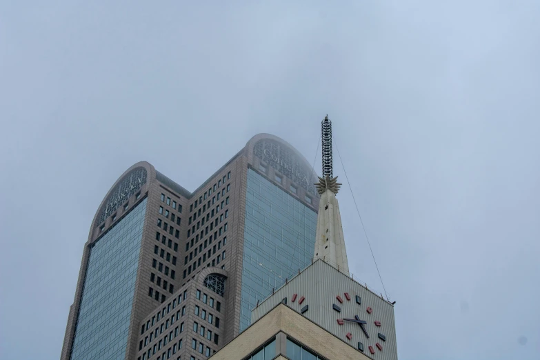 an architectural clock tower stands next to other buildings