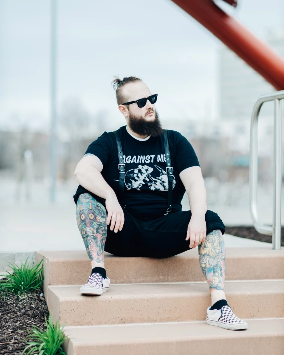 a person sitting down on some steps wearing a pair of shoes