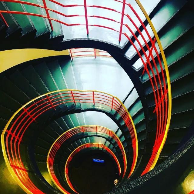 there are four spiral stairs with red railings