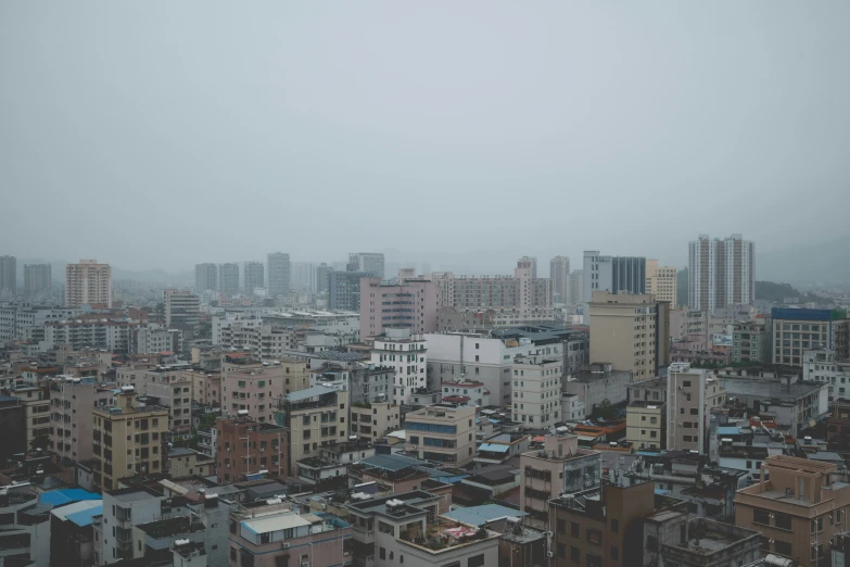 large buildings and a street light in a cloudy city