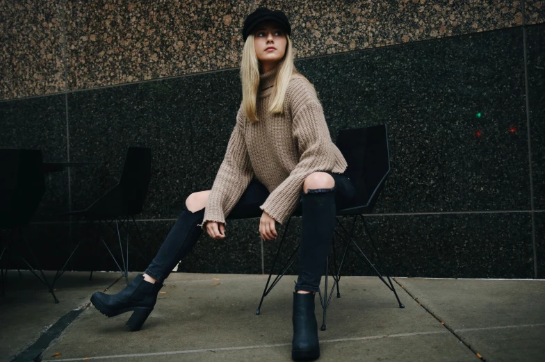 a beautiful blonde sitting on top of a chair