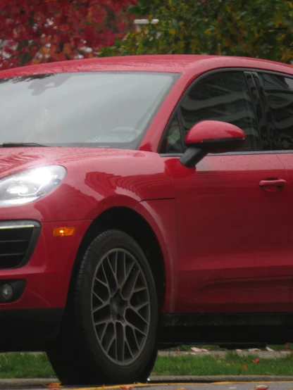 the red porsche macx is parked on the side of the road