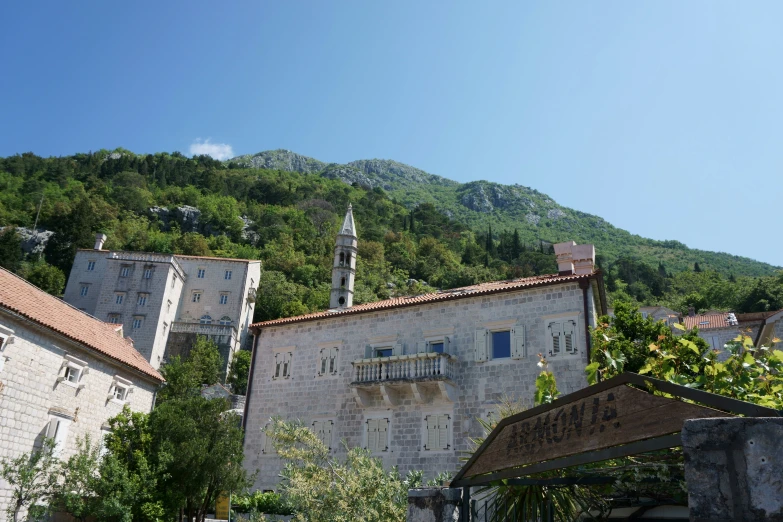 the old building with an arch sits on the hillside