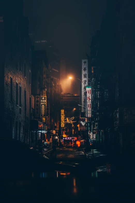 a city street at night with a building lit up