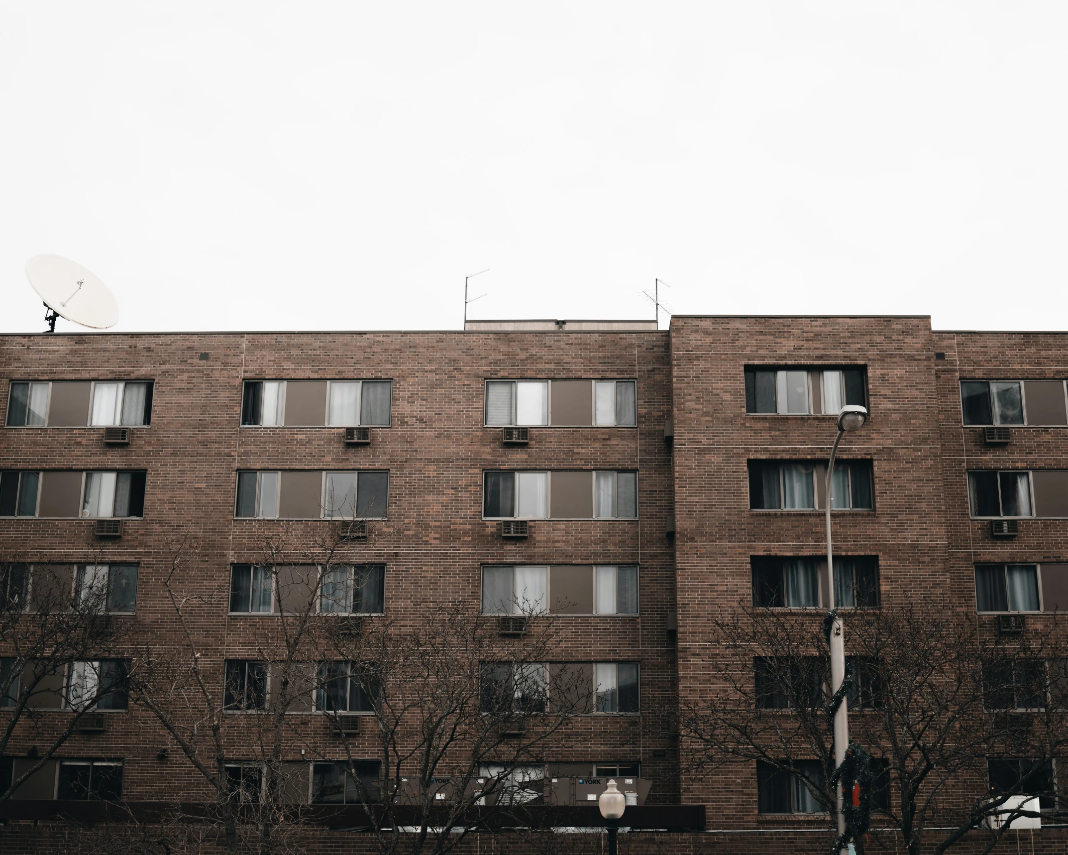 the front of a brick building that is made of bricks and has windows