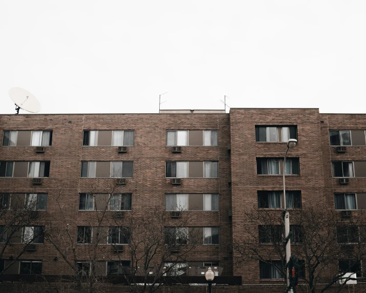 the front of a brick building that is made of bricks and has windows