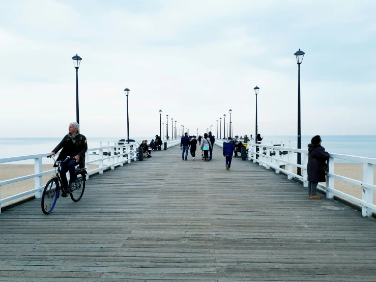 the boardwalk is busy with pedestrians and bicyclists