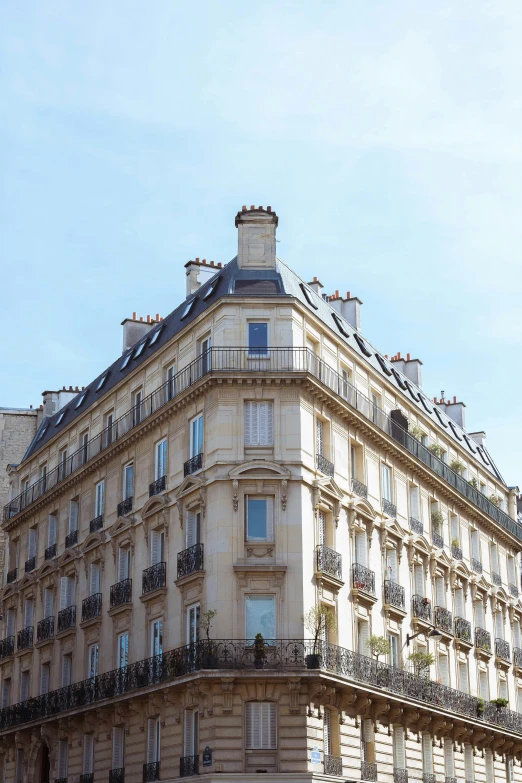 a tall building with balconies stands tall in front of a street