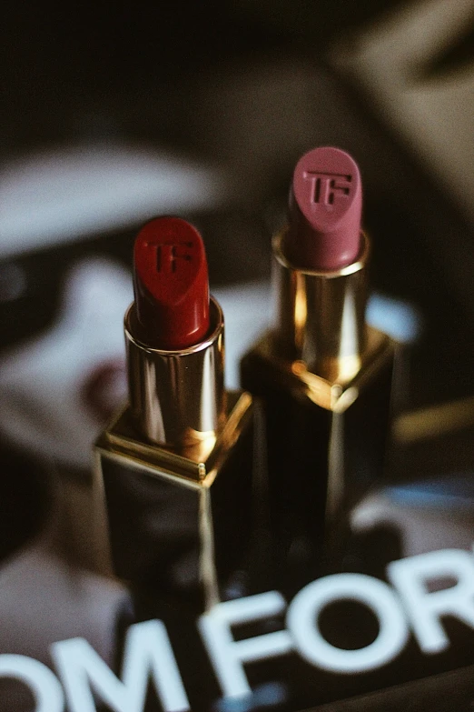 a lipstick sitting on top of a table next to another