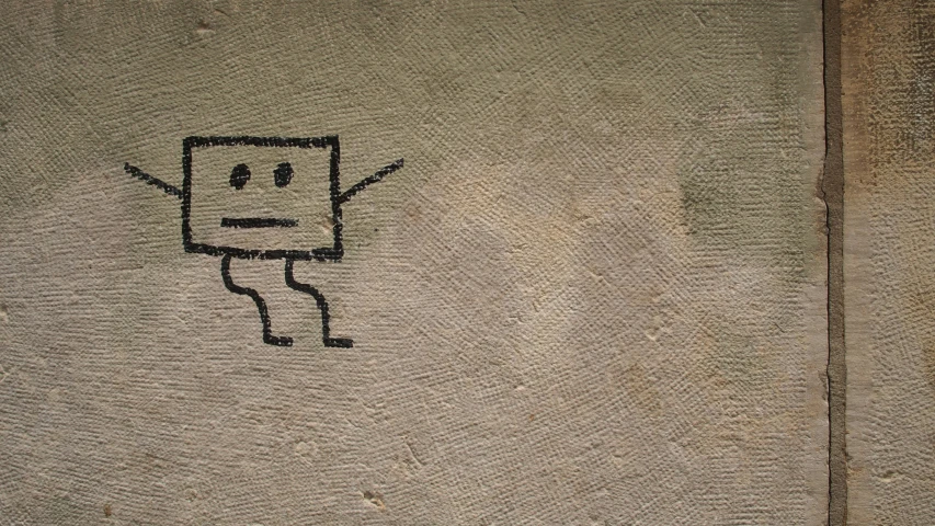 a drawing of a square piece with arms and legs with a smiling face