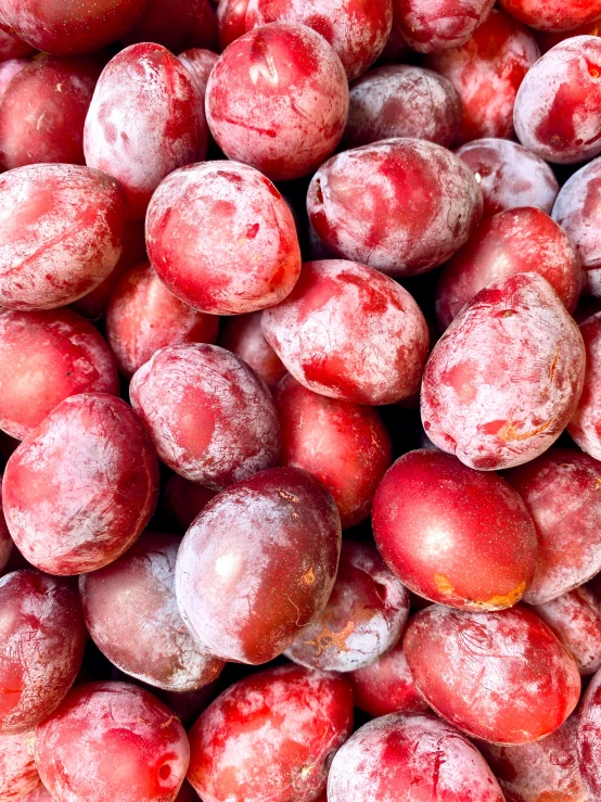 plums covered in ice sitting on top of each other