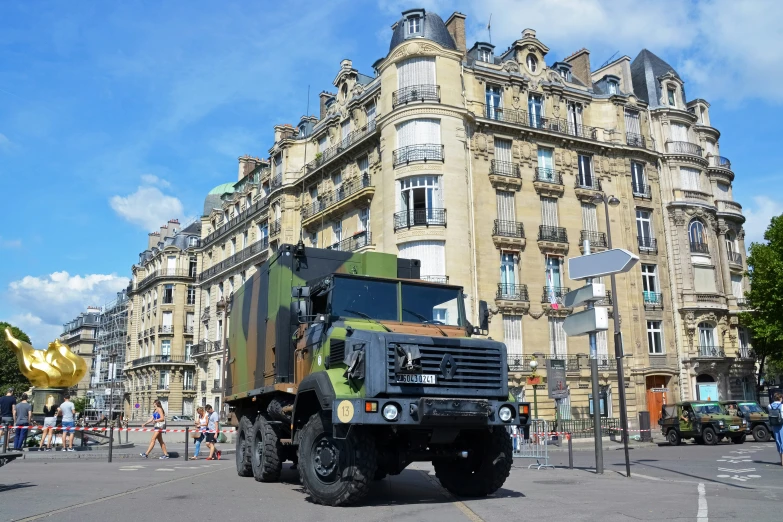 the truck is parked near a building in a city