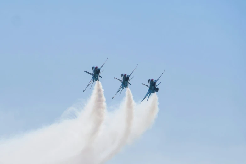 four jets flying through the air in formation