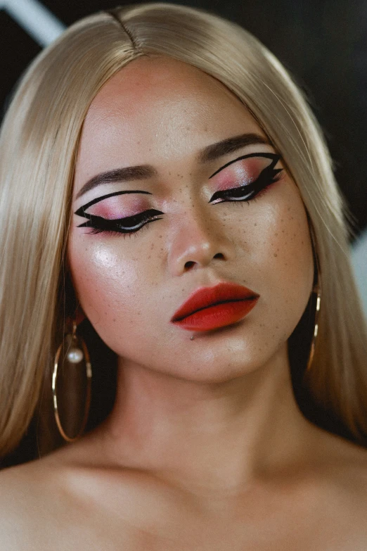 blonde woman with red lipstick and huge hoop earrings