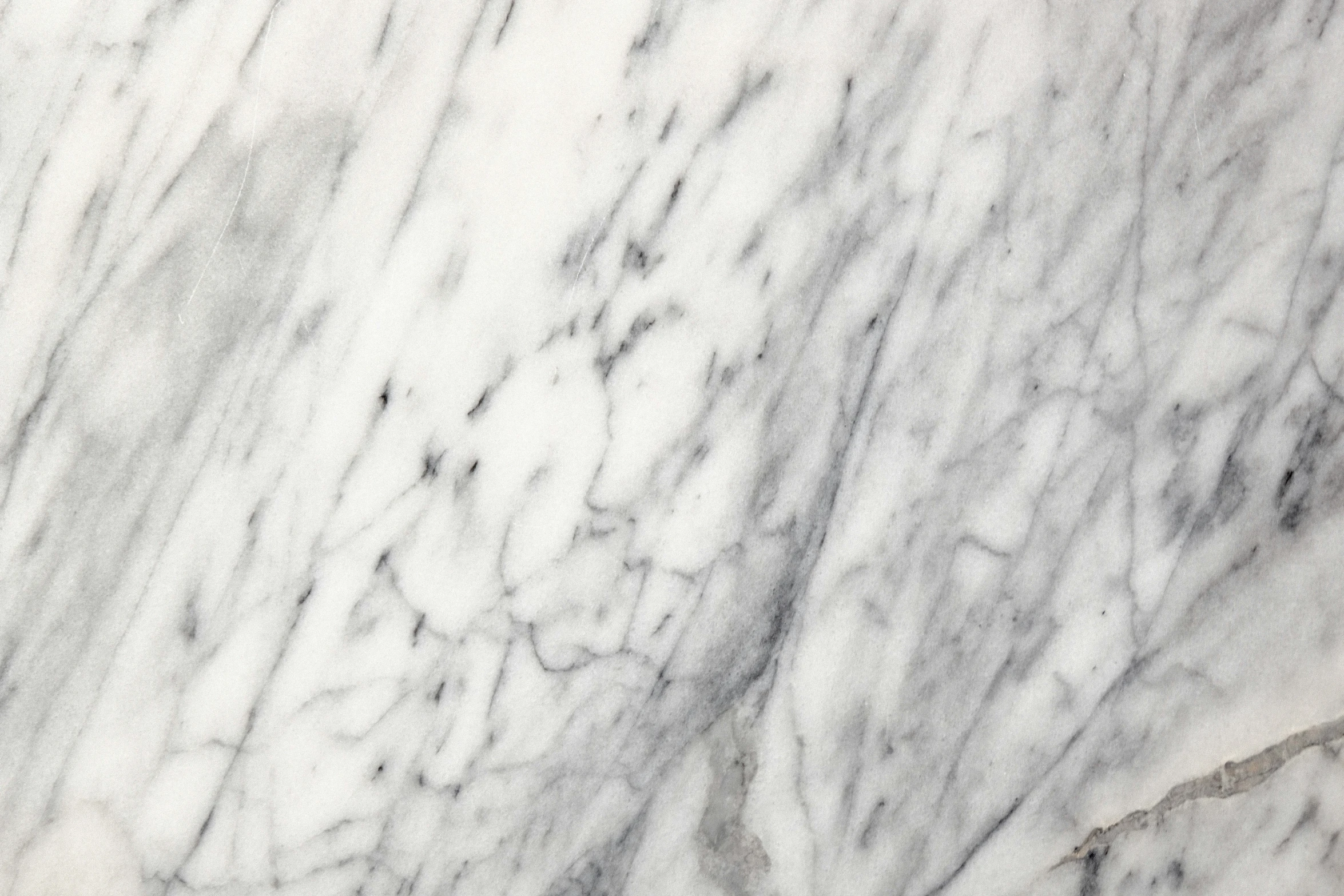 the surface of a marble wall with lines and spots