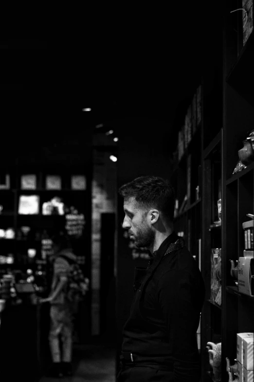 a man standing in a store while looking at soing