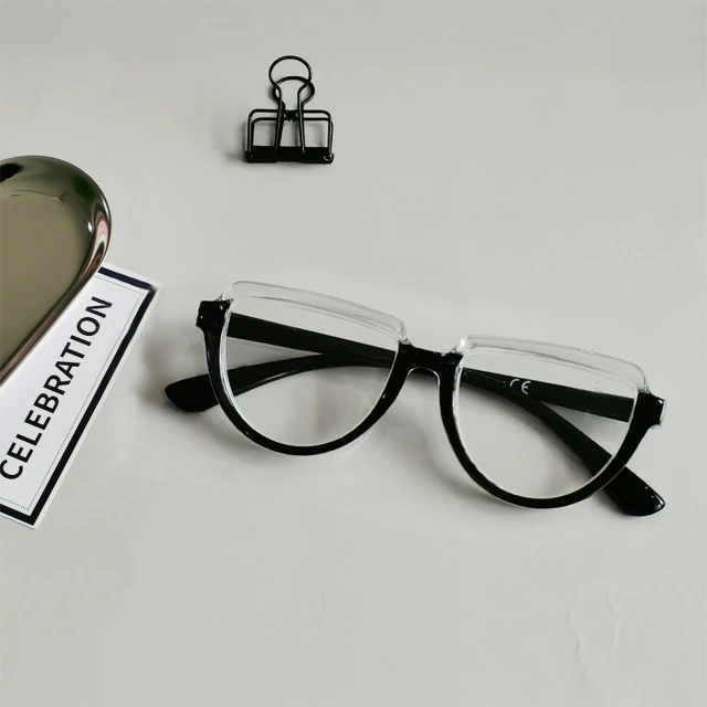 a white desk with two black glasses and a note on it