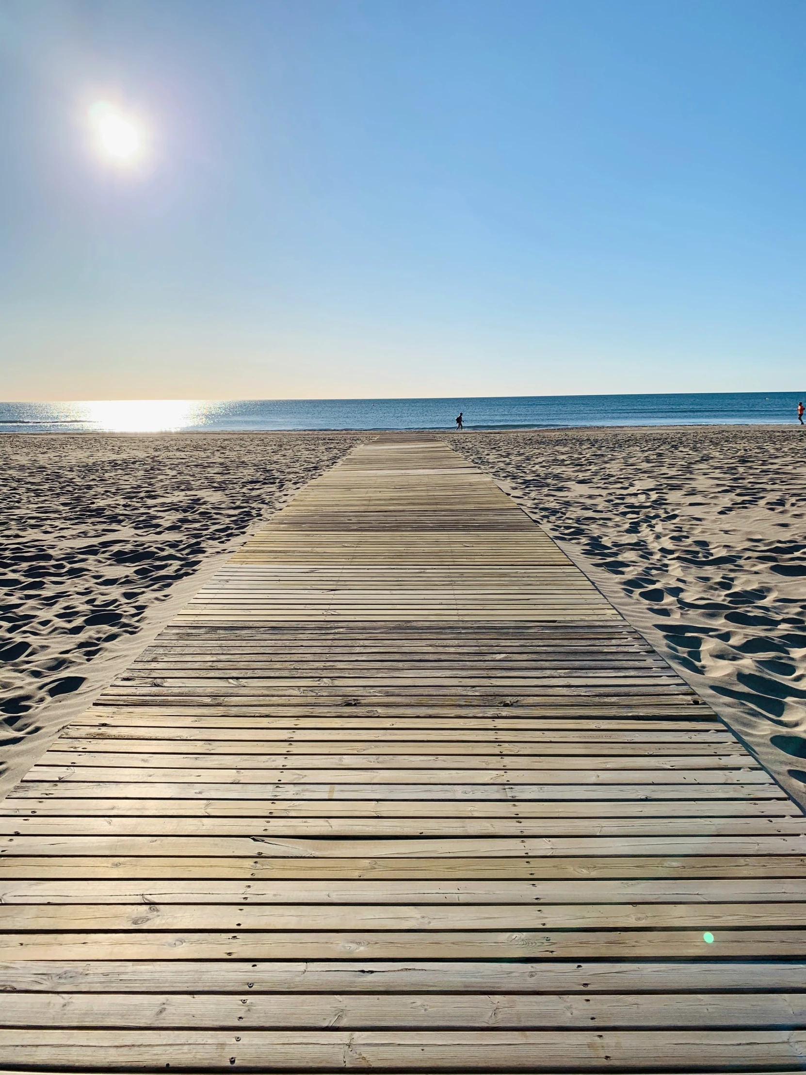 a long wood walkway leading to the water