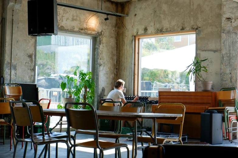 a woman sitting at a table in an old building