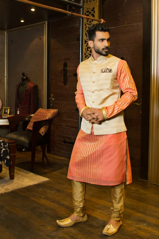 a man in a traditional indian outfit with an intricate head piece