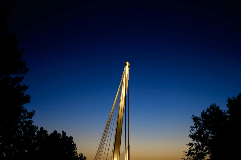 a light colored arch with a night sky behind it