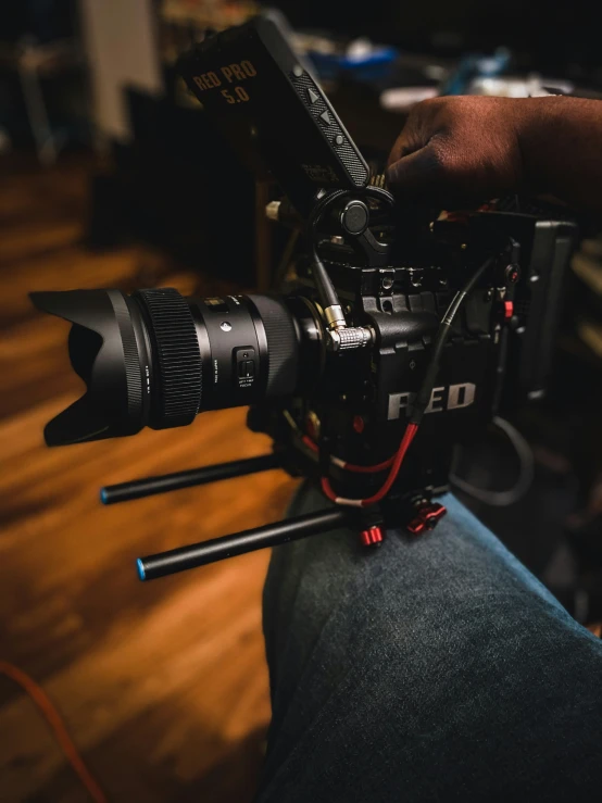 a man sitting down with a camera attached to his leg