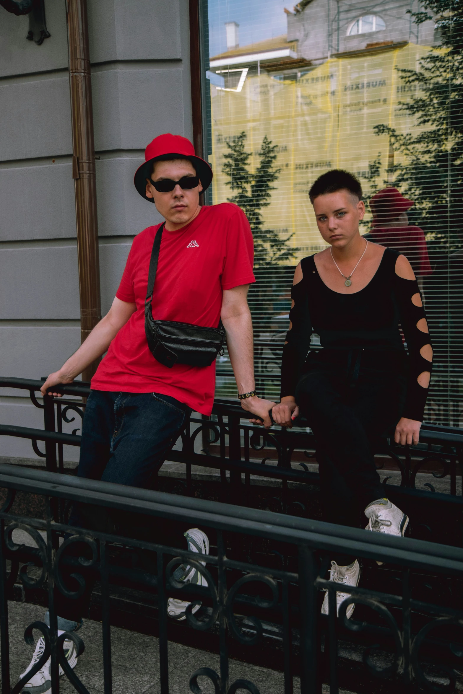 a man and woman in a red shirt outside of a building