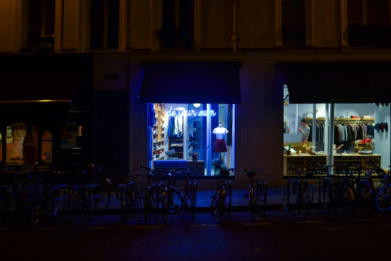 a dark street with several bicycles parked in front of it