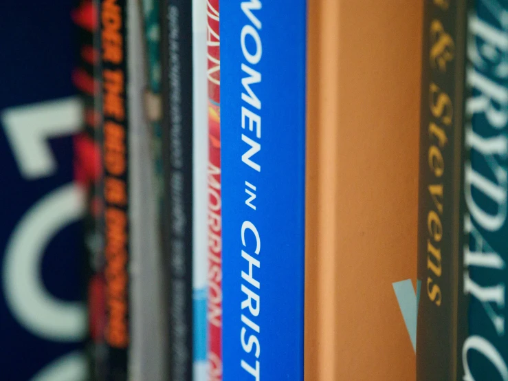 several books on an old shelf with a blurry background
