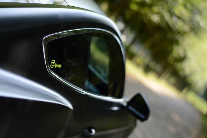 the reflection of a car is visible on a rear view mirror