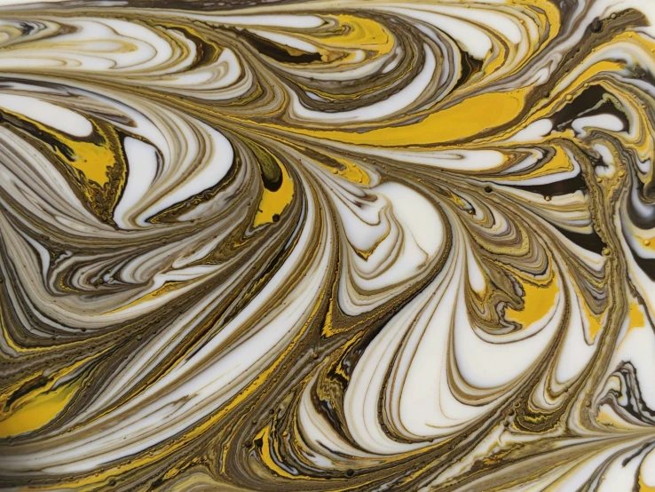 a golden yellow and black abstract acrylic paint swirl