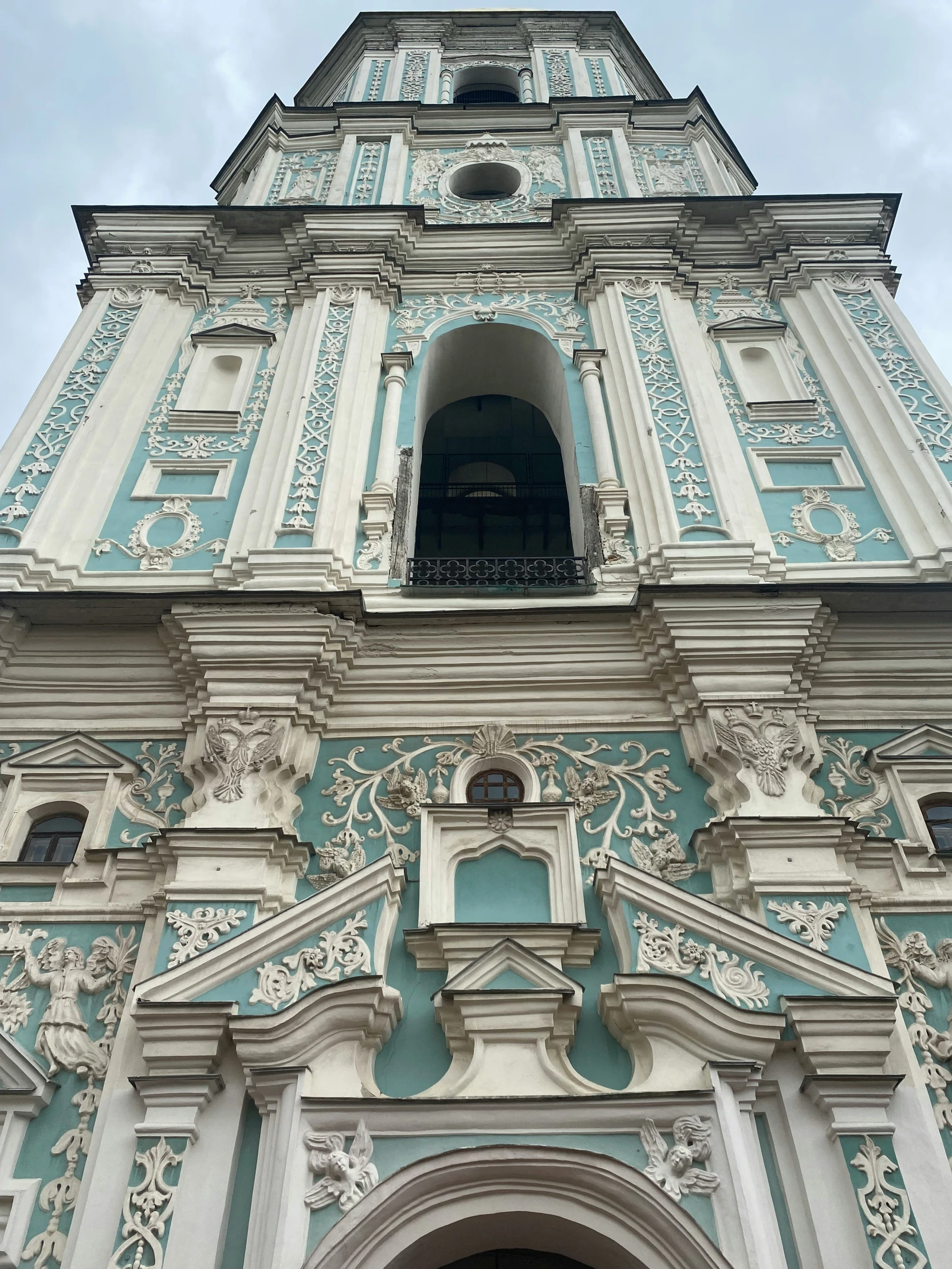 looking up at the top of an ornate church tower