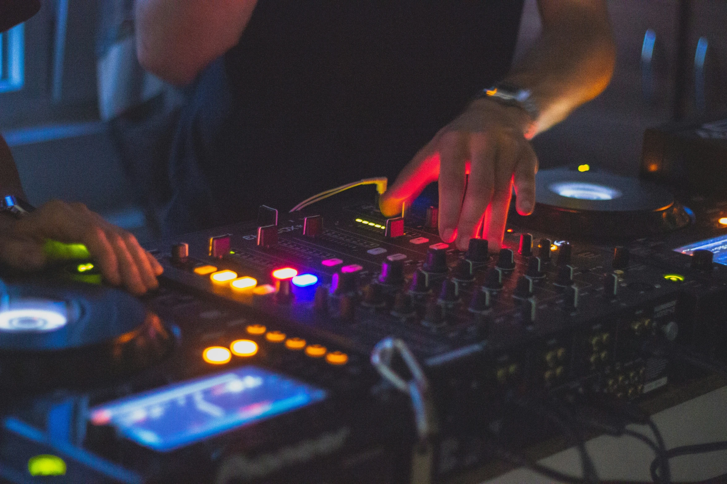 a dj mixing some musical items at a party