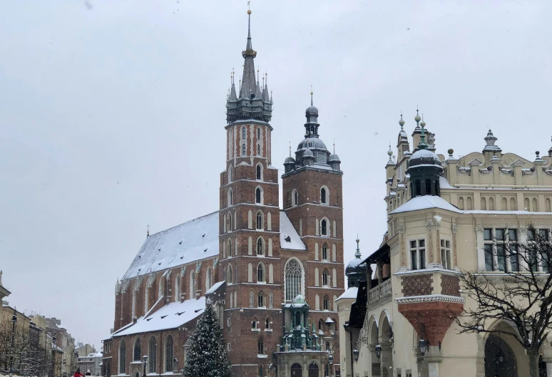 a large clock tower in the middle of some buildings