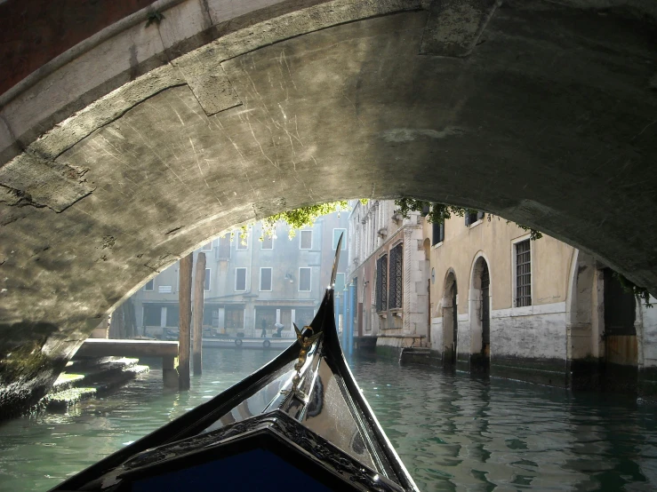 a boat ride on the water underneath a bridge